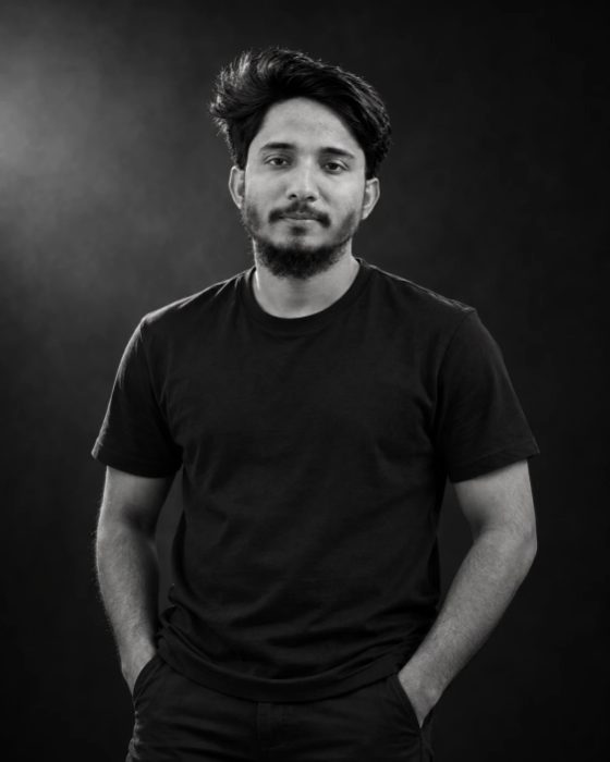 Saeed Mahmud, standing, in a black T-shirt